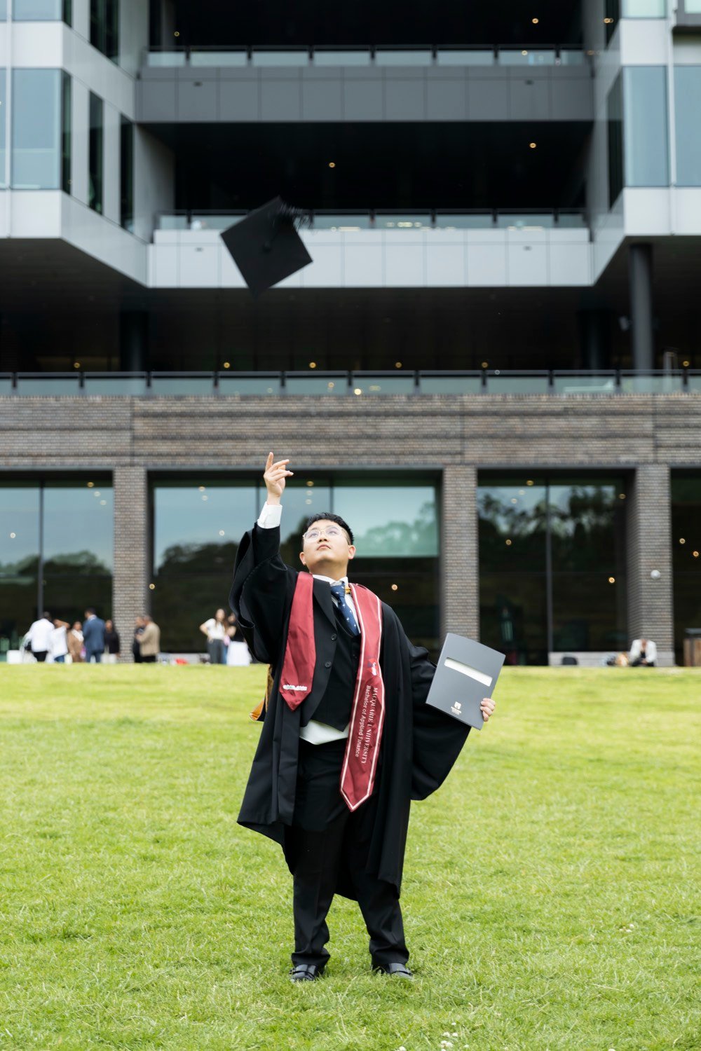 Graduate tossing his mortarboard in the air