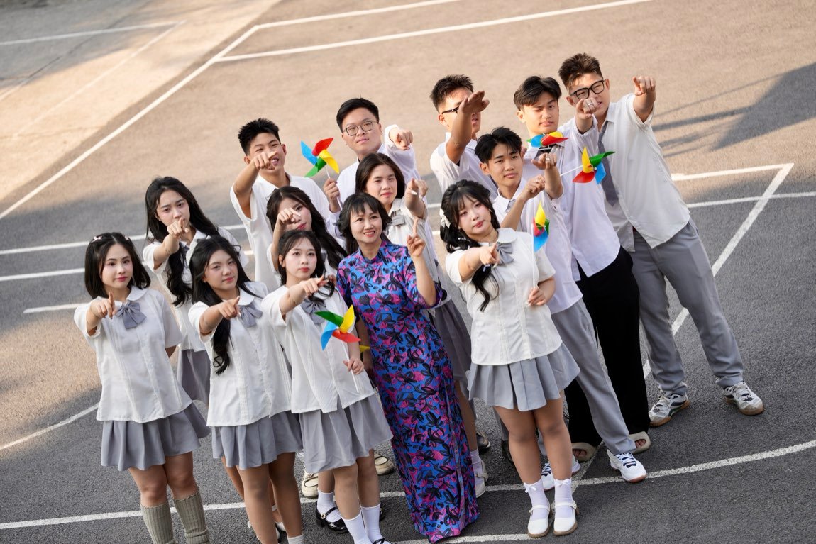 Class pointing at the camera with pinwheels